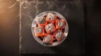 Glowing coconut shell hookah charcoal cubes on a heat management device showing steady heat performance for a smooth hookah session.